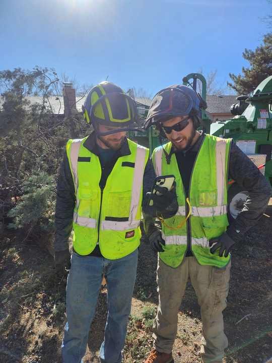 Crew member in safety gear next to the chipper